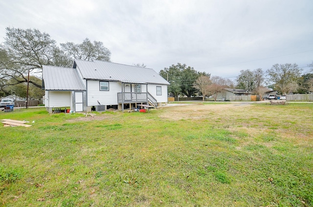 back of house featuring a yard and central AC unit