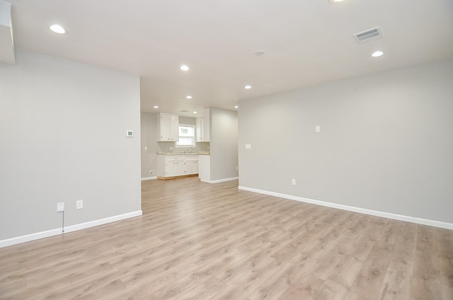 2706 Sledge St, Waller, TX 77484 - unfurnished living room featuring light wood finished floors, recessed lighting, and baseboards