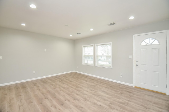 entrance foyer featuring a wealth of natural light and light hardwood / wood-style flooring