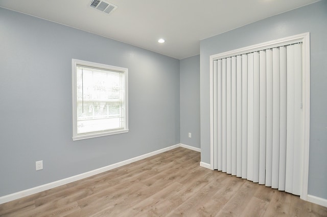 unfurnished room with light hardwood / wood-style flooring