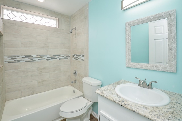 full bathroom with toilet, vanity, and tiled shower / bath