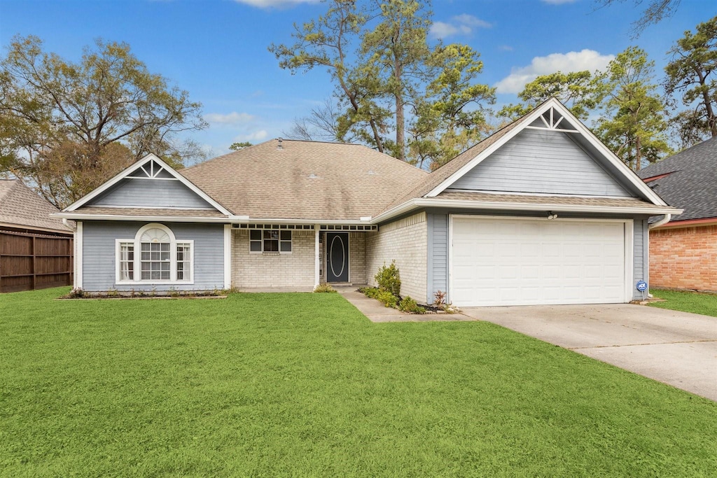 view of front of home with a front yard and a garage