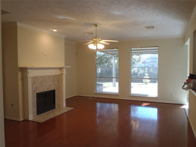 unfurnished living room with a fireplace, ceiling fan, a healthy amount of sunlight, and ornamental molding