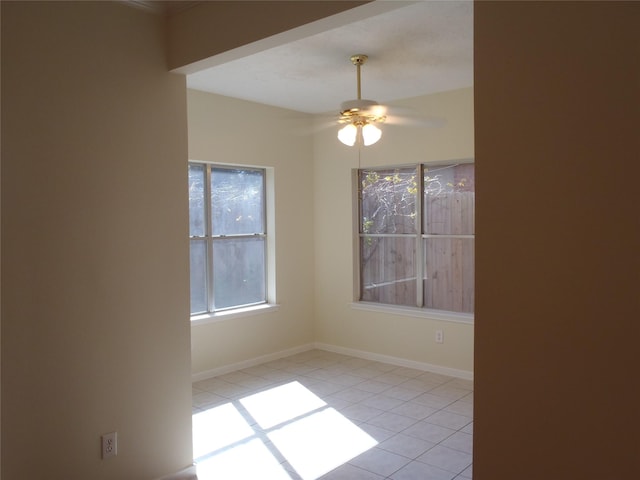 tiled spare room with ceiling fan