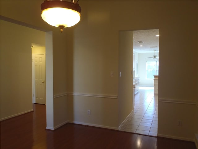 unfurnished room with ceiling fan and wood-type flooring