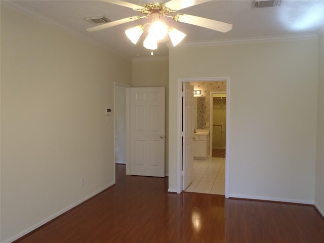 unfurnished room featuring hardwood / wood-style floors, ornamental molding, and ceiling fan