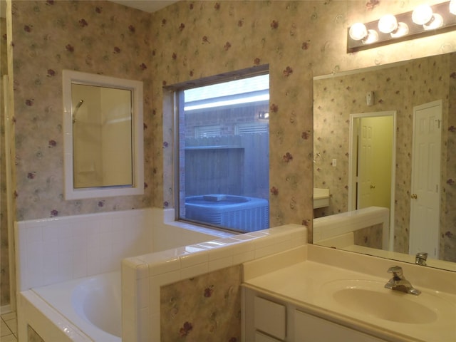 bathroom featuring vanity, tile patterned floors, and a tub