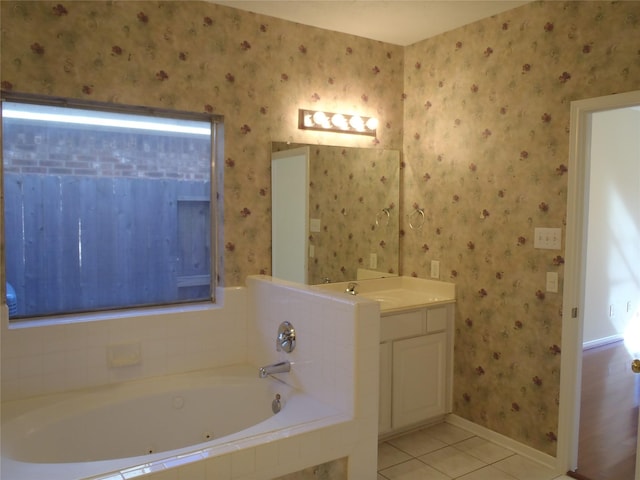 bathroom featuring tile patterned floors, tiled tub, and vanity