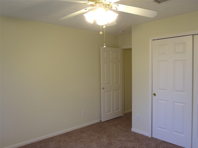 unfurnished bedroom featuring a closet, ceiling fan, and carpet