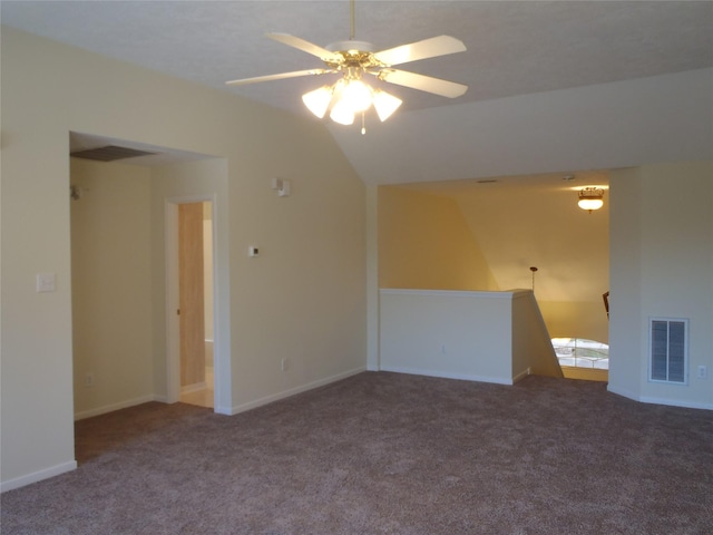 spare room with vaulted ceiling, ceiling fan, and carpet flooring