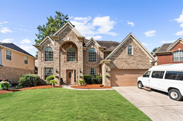 front of property with a front yard and a garage