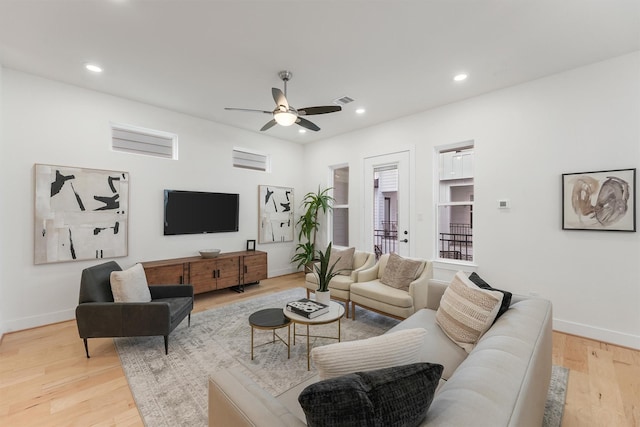 living room with ceiling fan and light hardwood / wood-style flooring