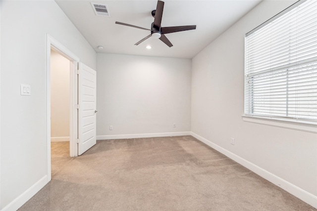 interior space featuring light colored carpet and ceiling fan