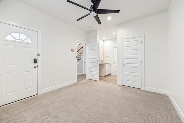 entryway featuring ceiling fan and light carpet