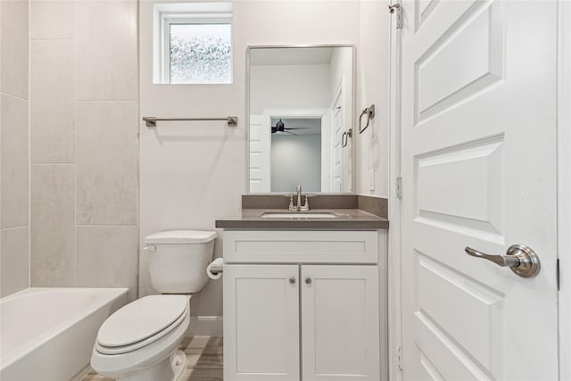 full bathroom with toilet, vanity, and tiled shower / bath