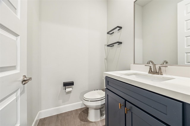 bathroom featuring toilet and vanity