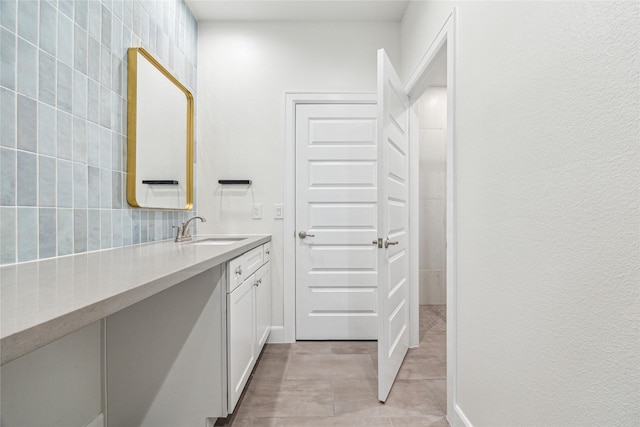 bathroom with tile patterned floors, backsplash, and vanity