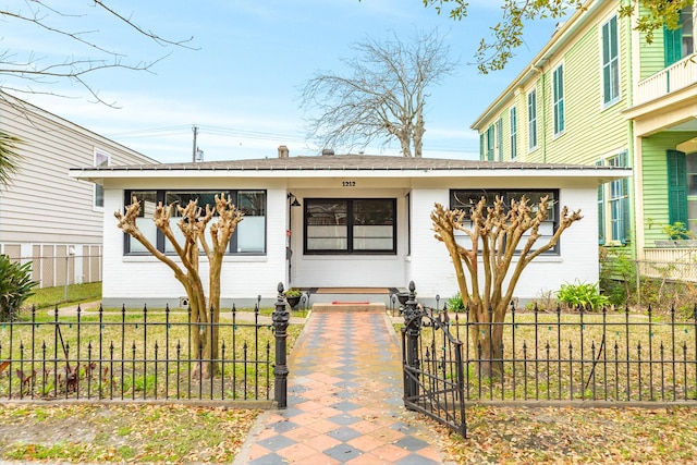 view of front of house featuring fence private yard and brick siding