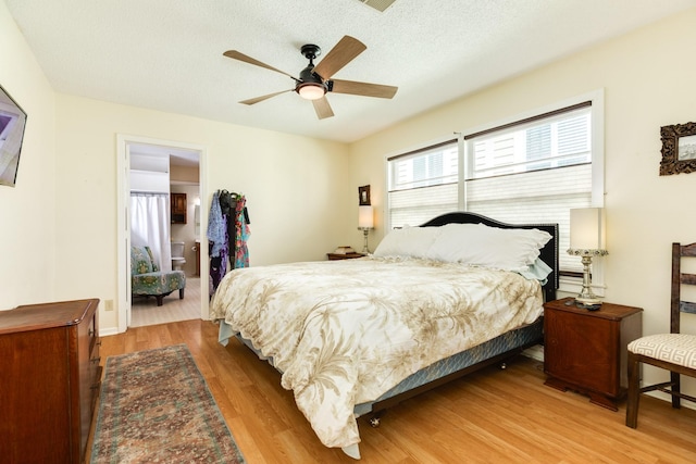 bedroom featuring a textured ceiling, ceiling fan, and wood finished floors