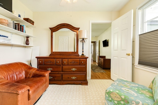 sitting room with a ceiling fan