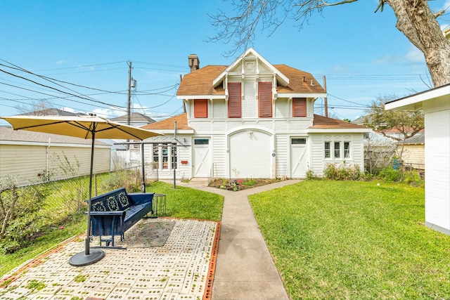 exterior space featuring a patio, a front lawn, and fence