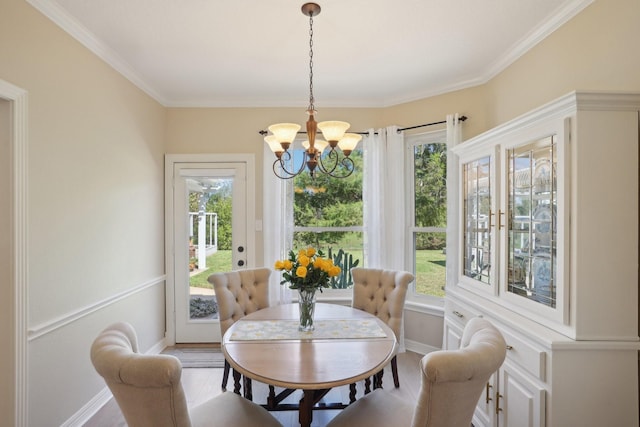 dining area featuring wood-type flooring, an inviting chandelier, and ornamental molding