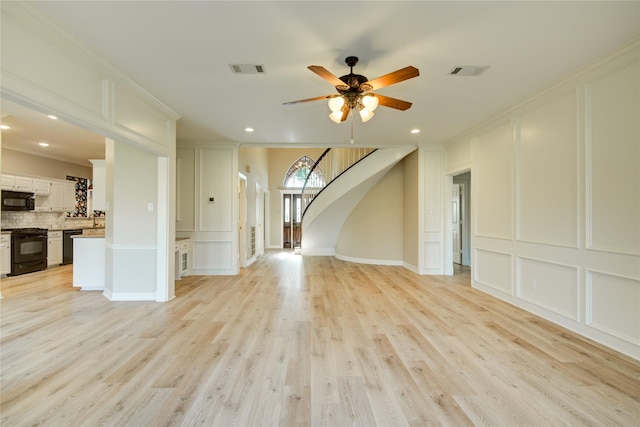 unfurnished living room featuring ornamental molding, ceiling fan, and light wood-type flooring