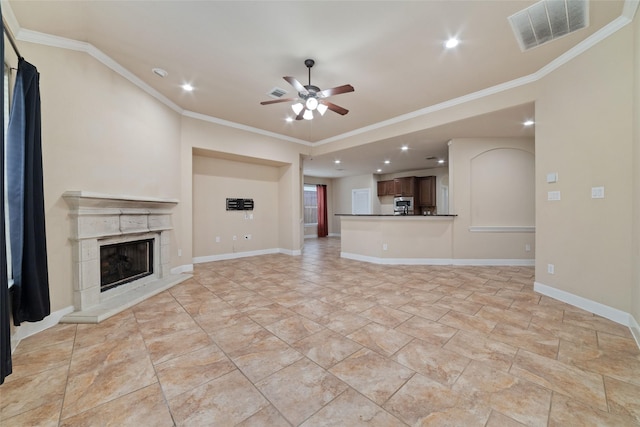 unfurnished living room with ornamental molding, ceiling fan, and a fireplace