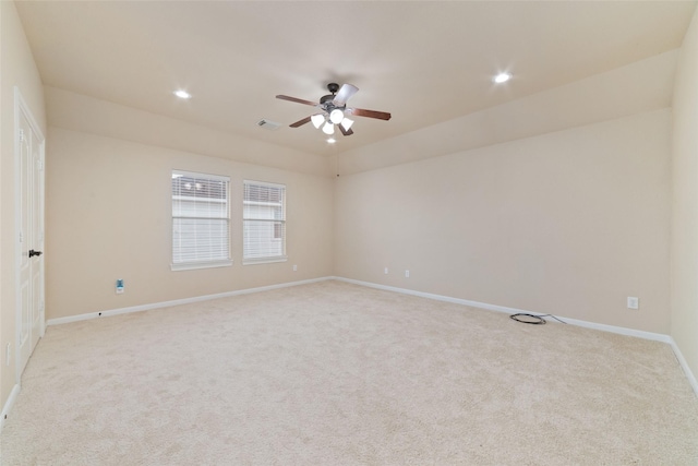 unfurnished room with ceiling fan, vaulted ceiling, and light colored carpet