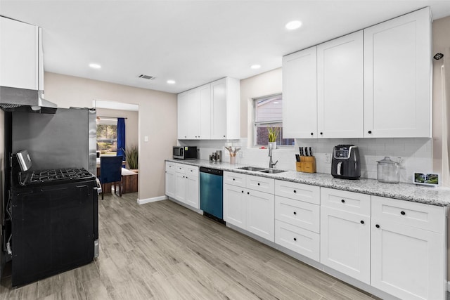 kitchen with stainless steel appliances, white cabinetry, light stone counters, and decorative backsplash