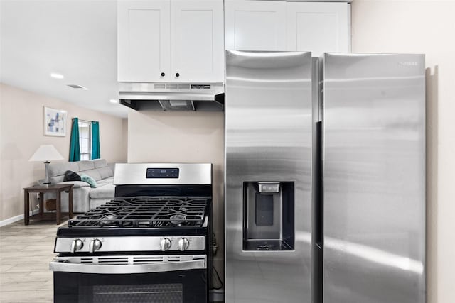 kitchen featuring white cabinetry, stainless steel appliances, and light hardwood / wood-style floors