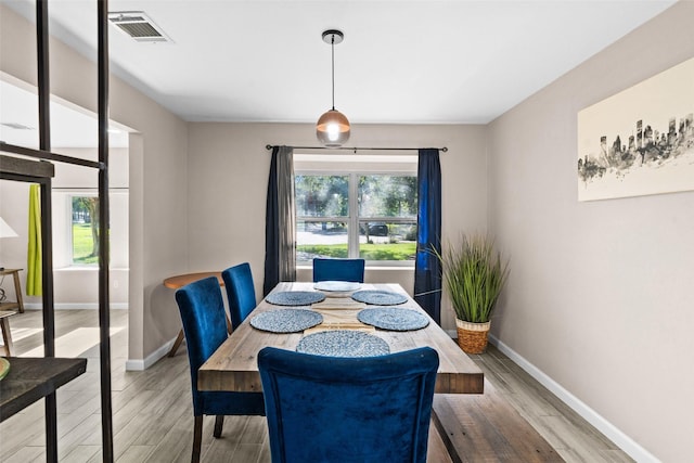 dining space with hardwood / wood-style flooring