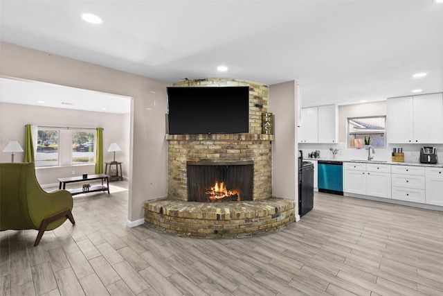 living room featuring sink and a fireplace