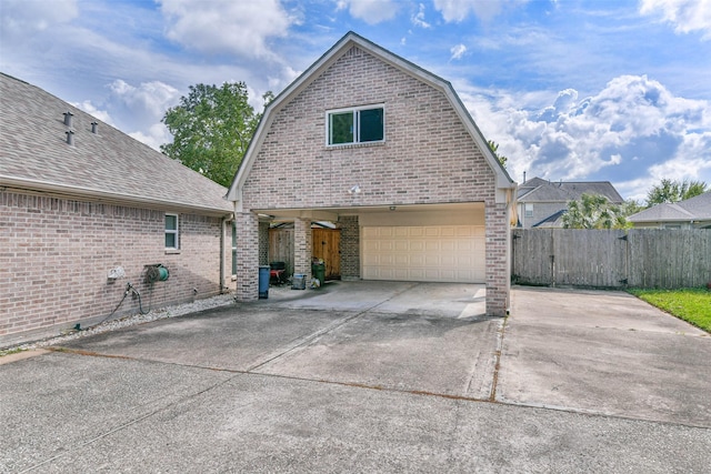 rear view of property featuring a garage