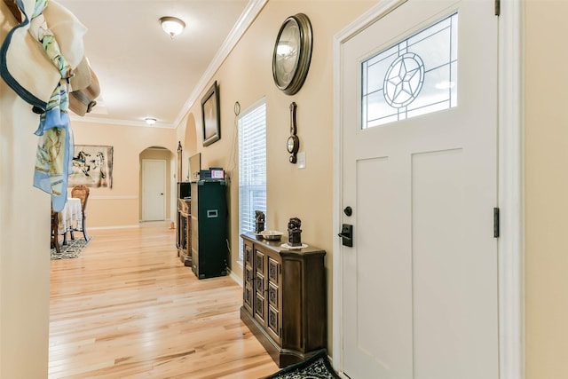 entryway featuring crown molding and light hardwood / wood-style flooring