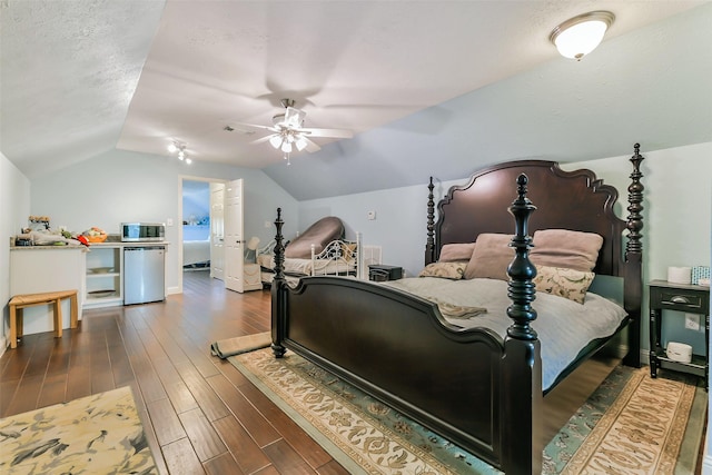 bedroom with lofted ceiling, a textured ceiling, ceiling fan, and dark hardwood / wood-style floors