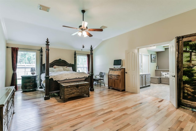 bedroom with vaulted ceiling, ceiling fan, light hardwood / wood-style floors, and connected bathroom