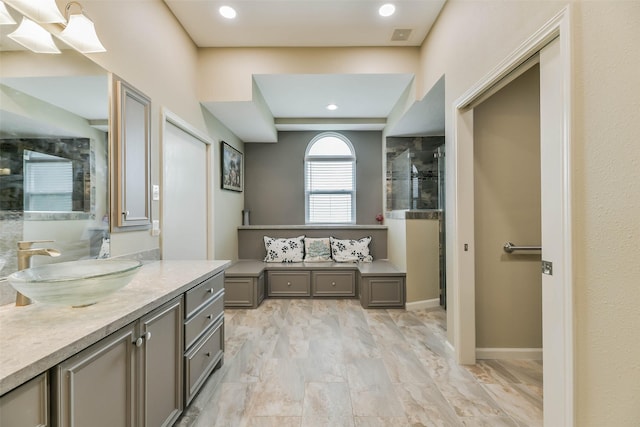 bathroom with an enclosed shower and vanity