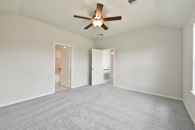 unfurnished bedroom with ensuite bathroom, light colored carpet, ceiling fan, and vaulted ceiling