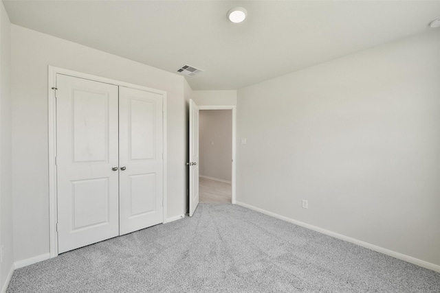 unfurnished bedroom with carpet and a closet