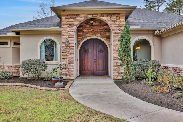 doorway to property featuring a lawn