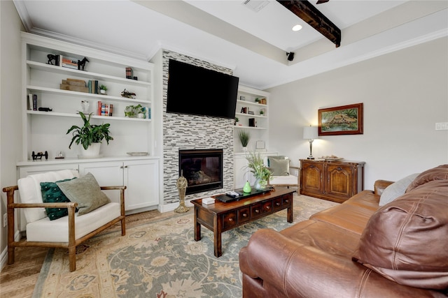 living room with built in shelves, a tiled fireplace, beam ceiling, and ornamental molding