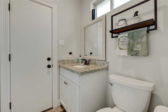 bathroom with toilet and vanity