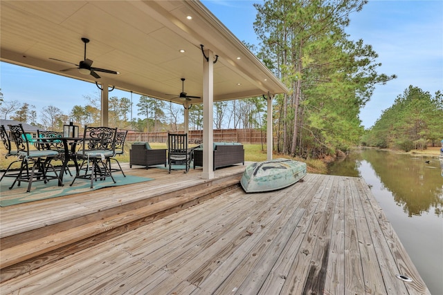 view of dock featuring outdoor lounge area and a deck with water view