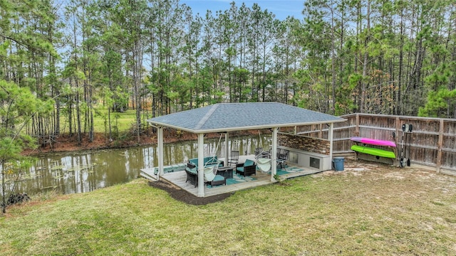 dock area with a lawn and a water view