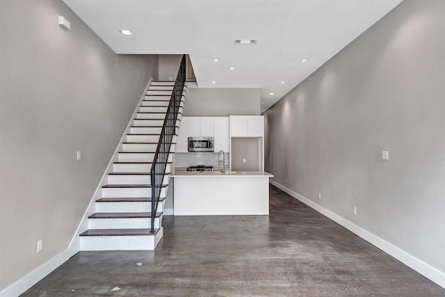 stairway with concrete flooring and sink