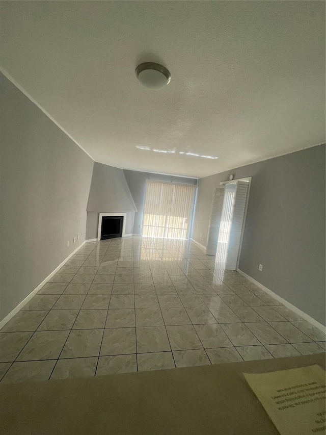 interior space featuring a large fireplace and light tile patterned floors