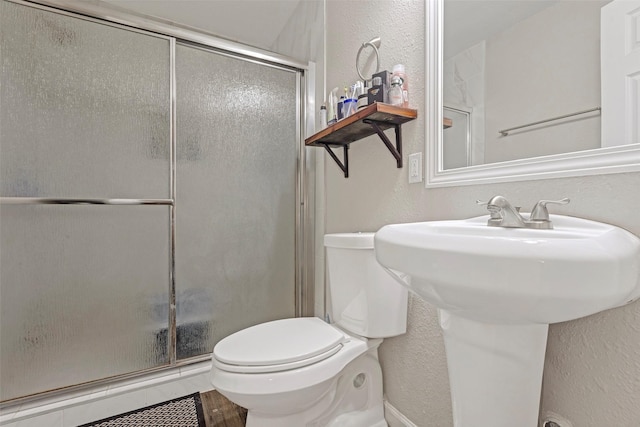 bathroom with toilet and walk in shower