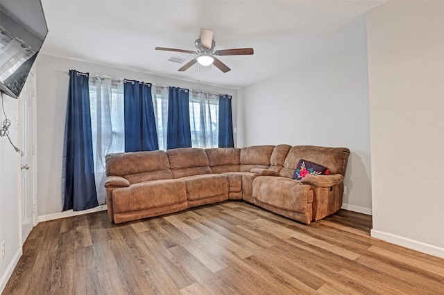 living room featuring ceiling fan and wood-type flooring