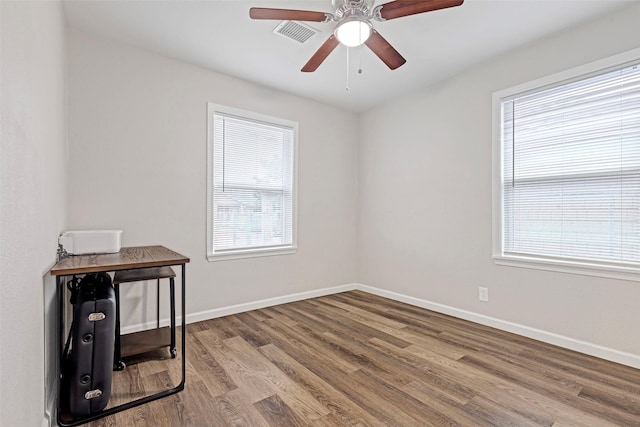 unfurnished room featuring hardwood / wood-style flooring, ceiling fan, and plenty of natural light